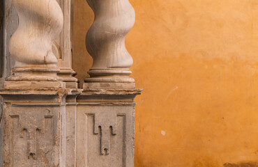 Detail of columns against orange wall. Granada, Spain