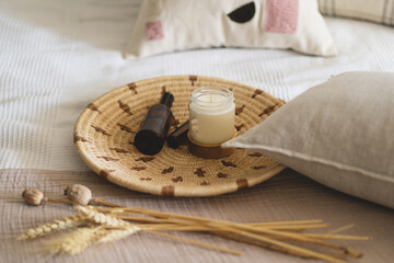 Linen pillows on a white bed with home decor. Still life details in home on a bed. Cozy home. Sweet home