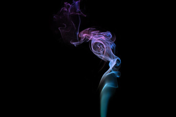 Multicolored smoke for aromatherapy relaxation on black background, beautiful swirled puffs of smoke
