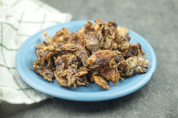 Deep fried salty squid on blue dish. The concept of preservation food