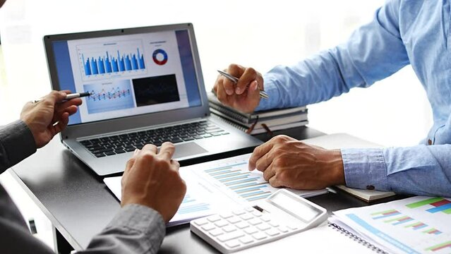 Business people discuss investment project working and planning strategy on laptop computer.