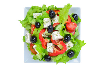 Greek salad isolated on a white background.