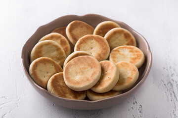A bowl of simple delicious homemade cookies baked in a pan on a light background