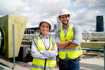 Portrait of two professional engineer or technician workers stand and look at camera with smiling...