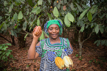 African farmer with freshly harvested cocoa pods from her plantation.