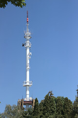 Obraz premium Radio broadcasting mast against the blue sky.