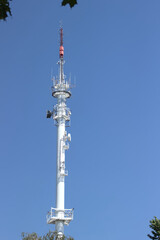 Radio broadcasting mast against the blue sky.