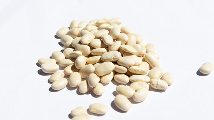 scattered dried bean grains and white background