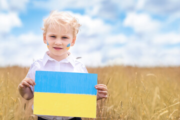 Stop War in Ukraine. Ukrainian boy with Ukrainina flag- yellow and blue stands against war.