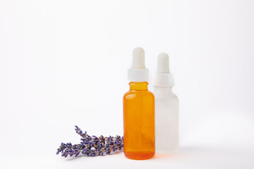 Lavender essential oil in glass bottle with pipette.Bottle with fragrant oil and lavender flowers isolated on white background.mockup of lavender essential oil with copy space.serum.