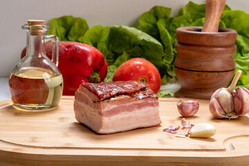 piece of  smoked bacon on a wooden board, ingredient, gastronomy,  preparation food