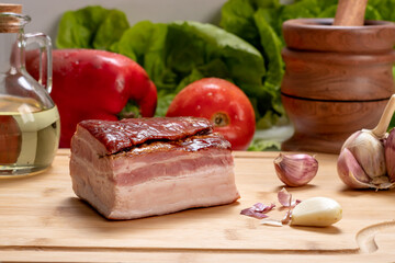 piece of  smoked bacon on a wooden board, ingredient, gastronomy,  preparation food