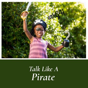 Portrait of african american boy playing pirate with talk like a pirate text, copy space