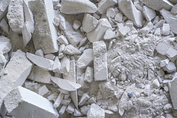 Construction waste debris - remains of white aac - autoclaved aerated concrete brick blocks, closeup detail - obrazy, fototapety, plakaty