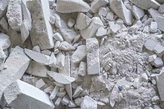 Construction waste debris - remains of white aac - autoclaved aerated concrete brick blocks, closeup detail
