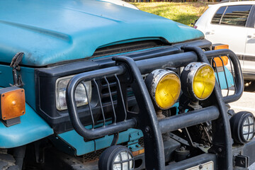 Off-road vehicle in dark blue with the inscription on the windshield in Portuguese "photographic expeditions". Toyota Land Cruiser FJ40 1980 year. All-wheel drive vehicle for extreme road conditions