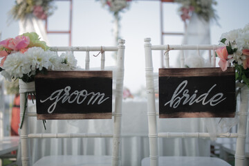 Wedding bride and groom Signs on chairs standing in the woods