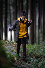 indian girl Walking in the forest in a yellow hoodie in Darjeeling in India