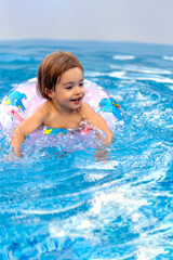 Fototapeta na wymiar beautiful little girl smiling while playing in the pool