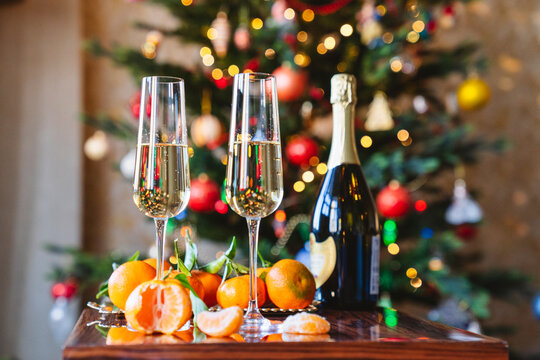 Two glasses of champagne in front of the Christmas tree.