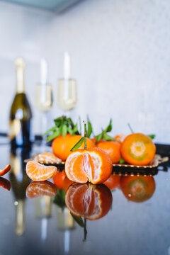 Still life of tangerines and glasses of champagne.