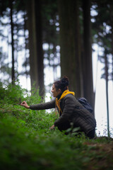 indian girl Walking in the forest in a yellow hoodie in Darjeeling in India