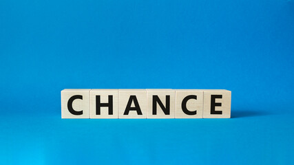 Chance symbol. Concept word Chance on wooden cubes. Beautiful blue background. Business and Chance concept. Copy space.