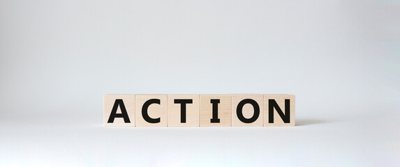 Action symbol. Concept word Action on wooden cubes. Beautiful white background. Business and Action...