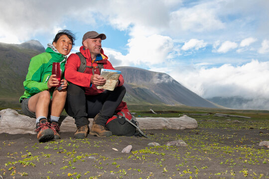couple resting during a hike in the remote east fjords of Iceland