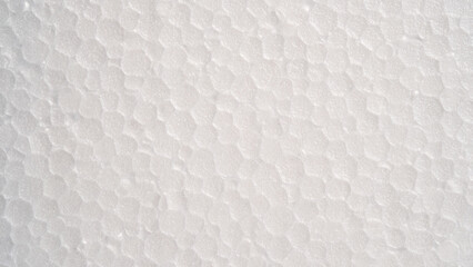 Fototapeta na wymiar White foam sheet top view. Small and large clear foam beads, polystyrene sheet surface in closeup, close-up seamless background