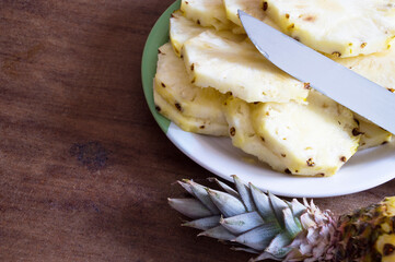 Pineapple cut into slices on a plate