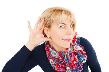 Funny woman holds her hand to the ear, listening. Isolated on white background. Studio shot