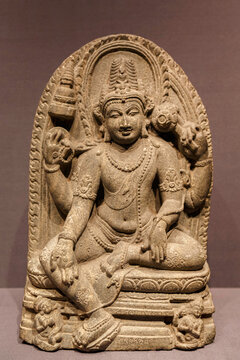 ancient seated bodhisattva stone statue image in 9th - 10th century from India. ancient art, religion and history concept.
