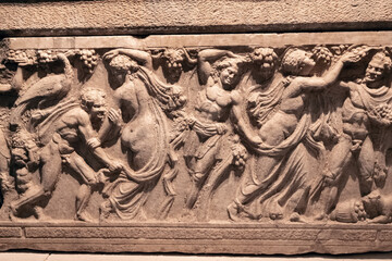 Bas-relief on the sarcophagus depicting a bacchanal led by the god of fun and wine - Dionysus - obrazy, fototapety, plakaty