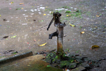 Hand-operated water pump, rusted and forgotten