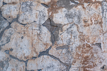 The concrete texture, wall, with cracks and scratches can be used as a background