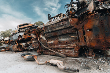 Fototapeta premium BUCHA, UKRAINE 22.06.2022 Irpin, Bucha. Car cemetery. Cars destroyed as a result of the war. A mountain of cars burned.