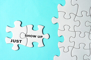 Just show up words on two pieces of white jigsaw puzzle on blue background.