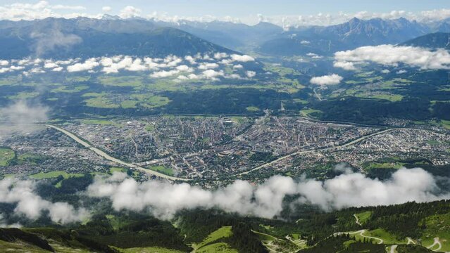 Innsbruck, Austria top view from Hafelekar, Nordkette mountains, with layers of low clouds over the city. Tourism, timelapse, aerial.
