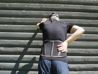 Support belt for back. Lumbar brace on the human body. Man with back pain