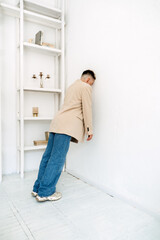 Sad lonely depressed unhappy hopeless woman standing near wall. Burnout, emotional problems,...