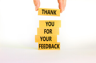 Thank you for feedback symbol. Concept words Thank you for your feedback on wooden blocks on a...