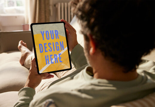 Mockup Of A Man Holding A Tablet From Behind