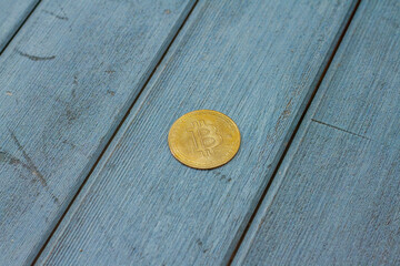 bitcoin gold coin place on wooden background. Online payment technology, digital wallet, cryptocurrency trading and mining investment concept.