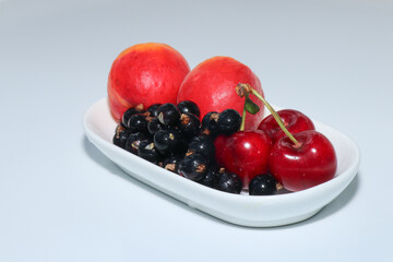 Juicy and delicious apricots, cherries and currants isolated on a white background. Berries and fruits