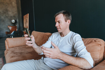 Young man using smartphone having video call