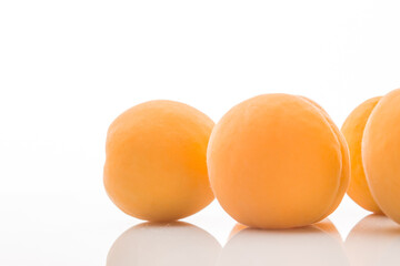 Yellow ripe apricots on a white background