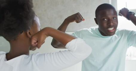 Vertical video of african american father and daughter brushing teeth