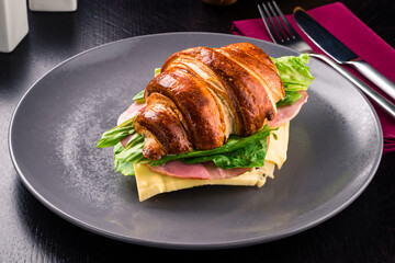 Sandwich with ham and cheese on croissant bun. Tasty croissant sandwich