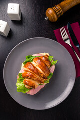 Sandwich with ham and cheese on croissant bun. Tasty croissant sandwich